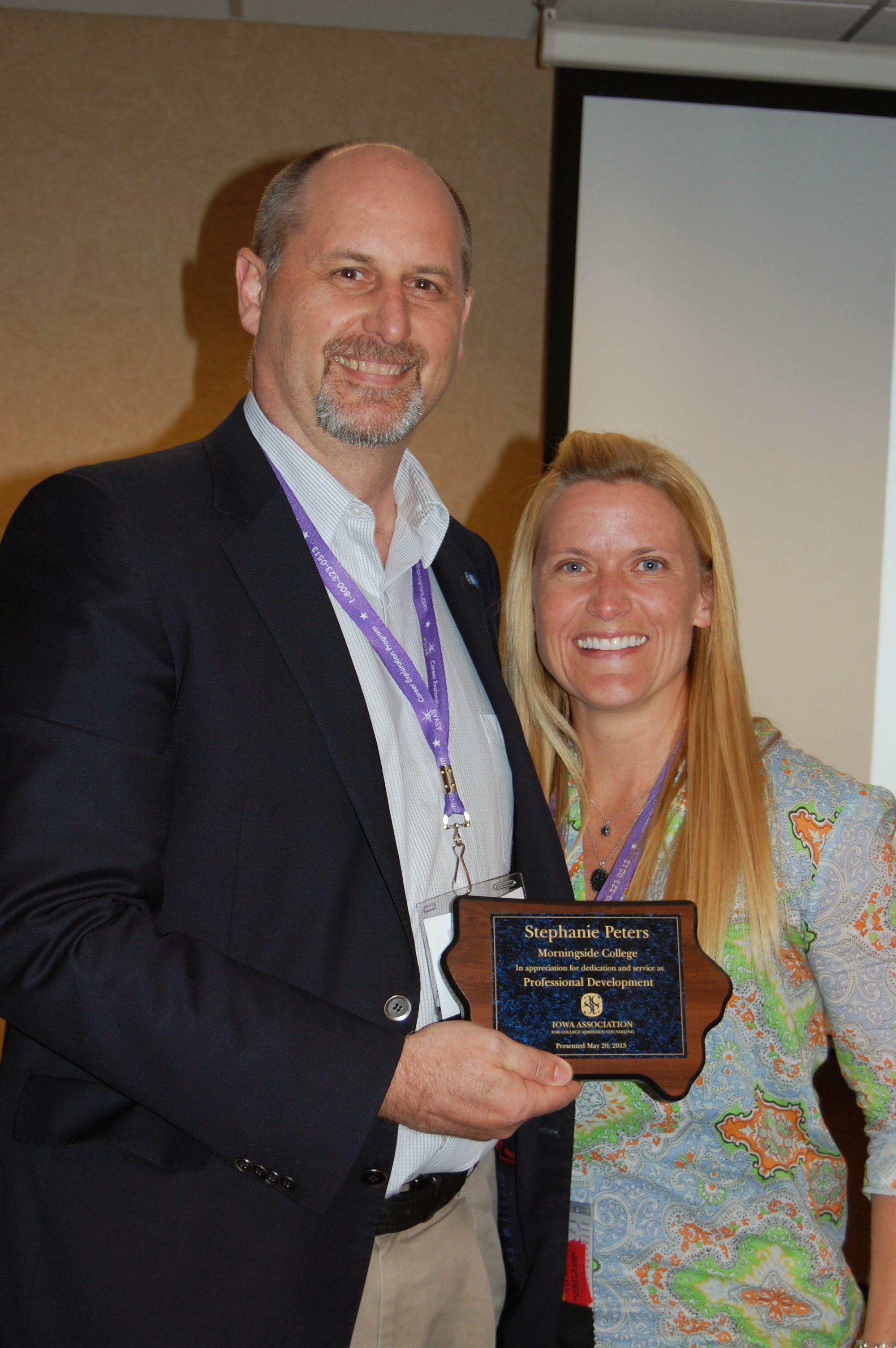 Man and woman with award